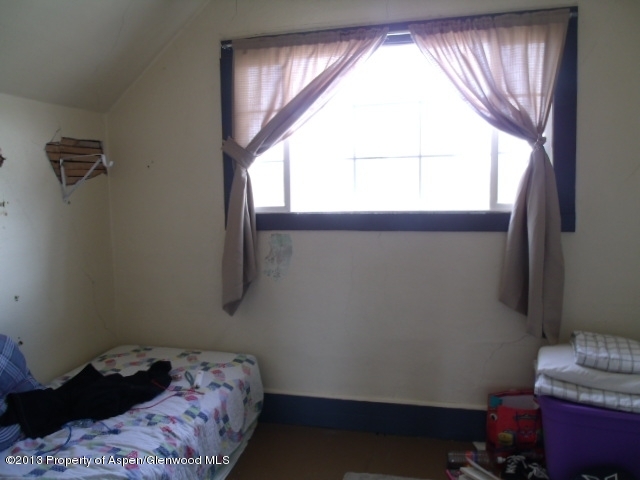 126 West 4th Street Rifle, CO 81650 - Photo 4 of 16 a bedroom with a bed and a window