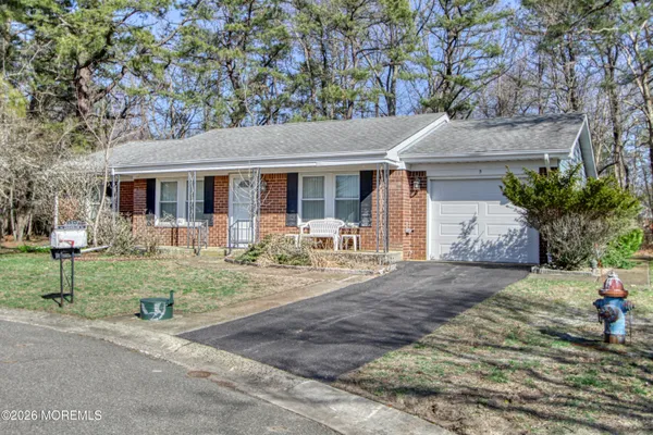 a kitchen with a refrigerator sink and cabinets