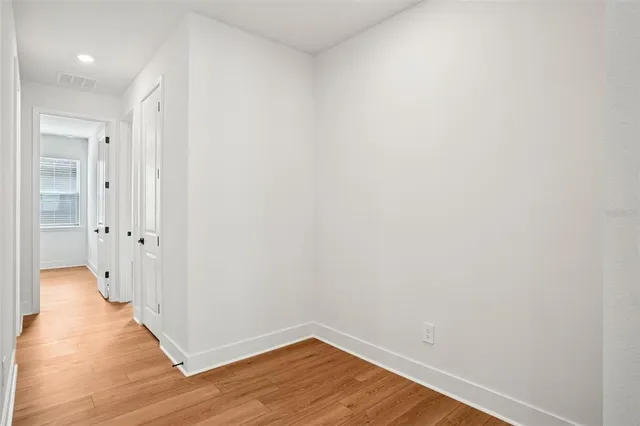a view of a hallway with wooden floor