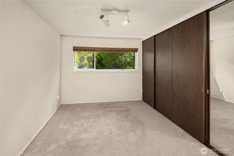 an empty room with large window and doors