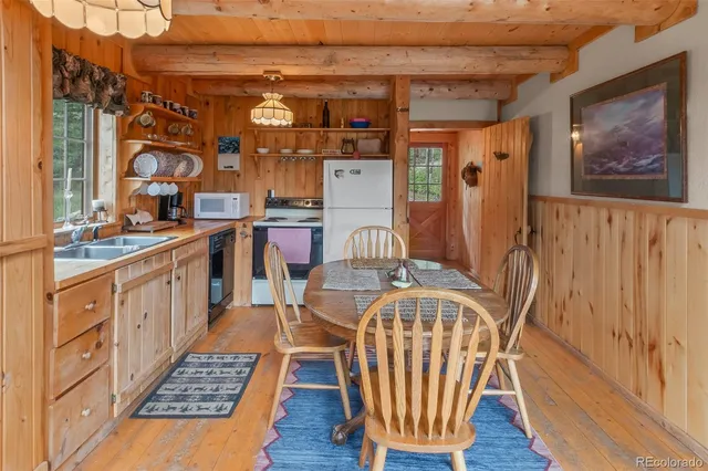 a dining room with furniture and wooden floor
