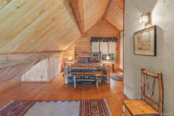 a bedroom with a bed a table and chair