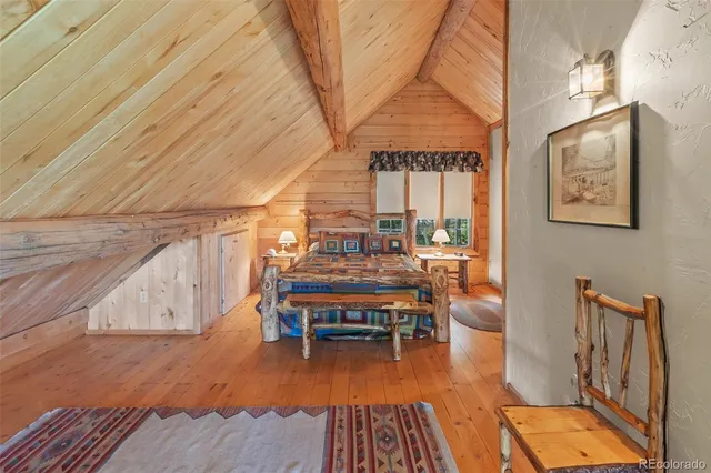 a bedroom with a bed a table and chair