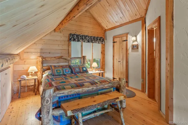 a bed sitting in a bedroom next to a window