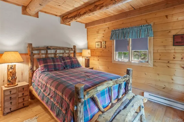 a bed sitting in a bedroom next to a window