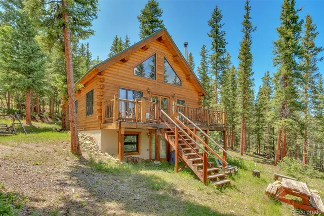 a view of a balcony with chairs and wooden floor