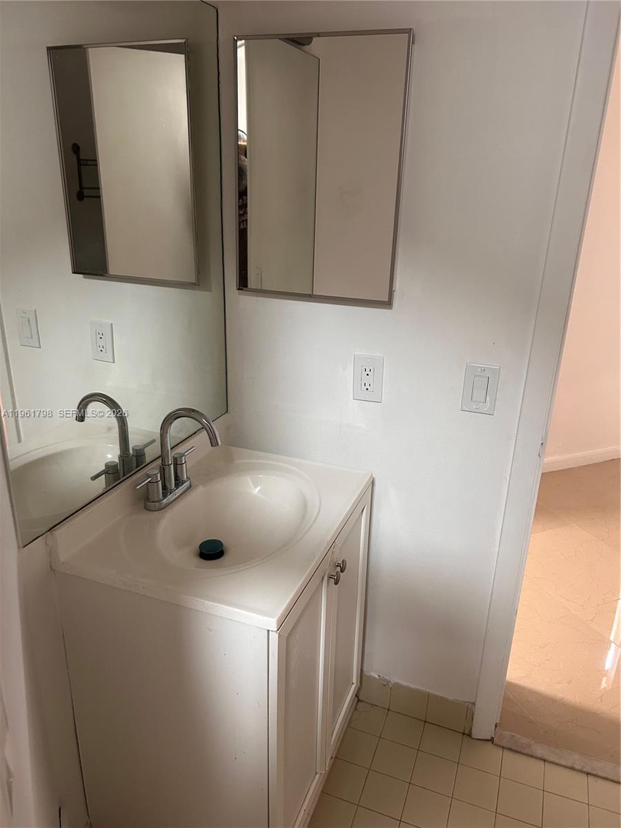 7450 Northwest 34th Street Lauderhill, FL 33351 - Photo 11 of 25 a bathroom with a double vanity sink and mirror