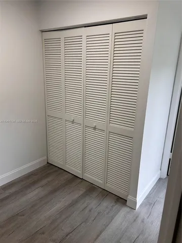 an empty room with wooden floor