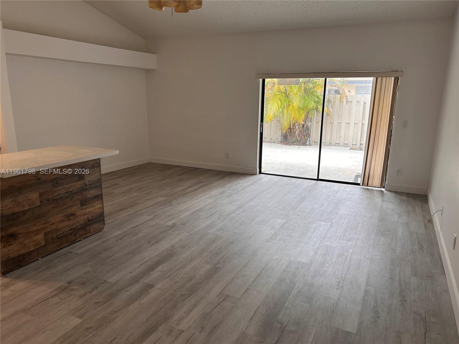 7450 Northwest 34th Street Lauderhill, FL 33351 - Photo 5 of 25 an empty room with wooden floor and windows