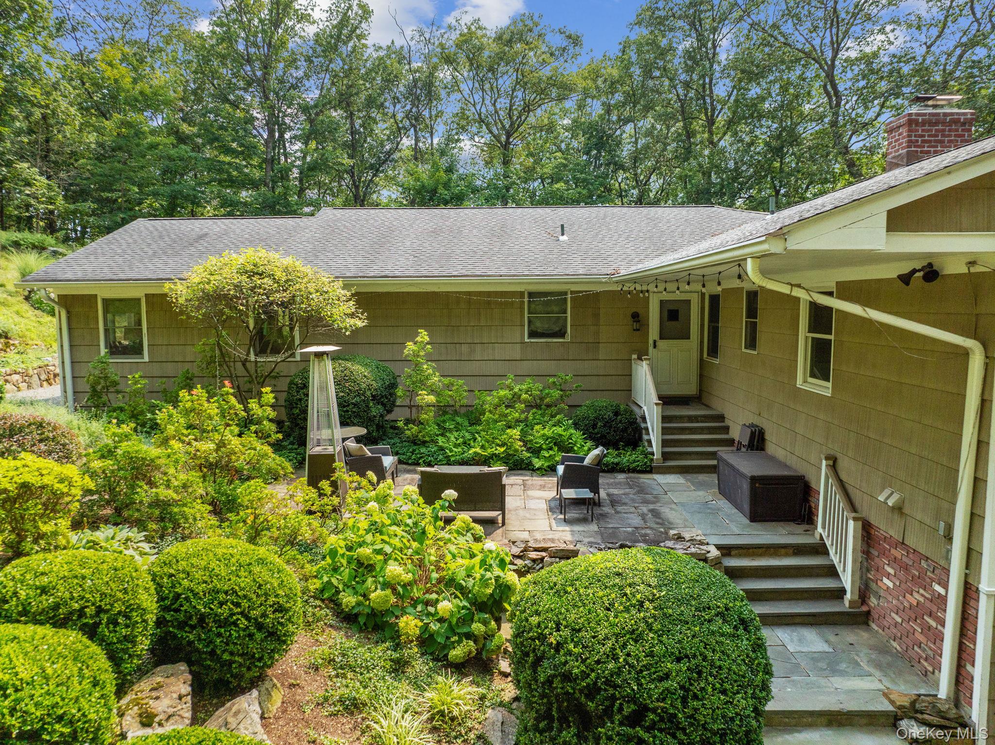 39 Mayberry Road Chappaqua, NY 10514 - Photo 1 of 44 a view of a house with a small yard plants and large tree