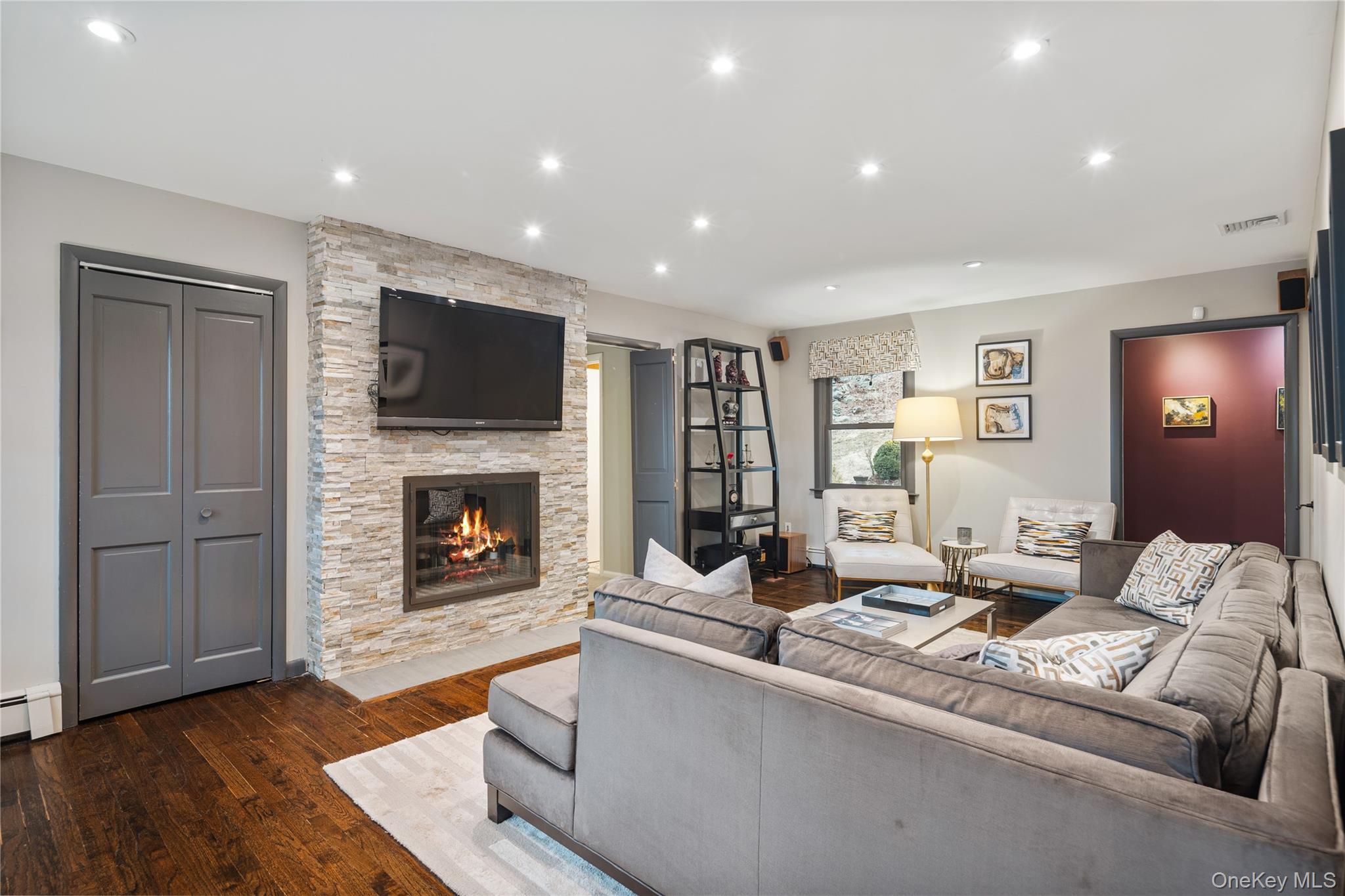 39 Mayberry Road Chappaqua, NY 10514 - Photo 22 of 44 a living room with furniture a fireplace and a flat screen tv