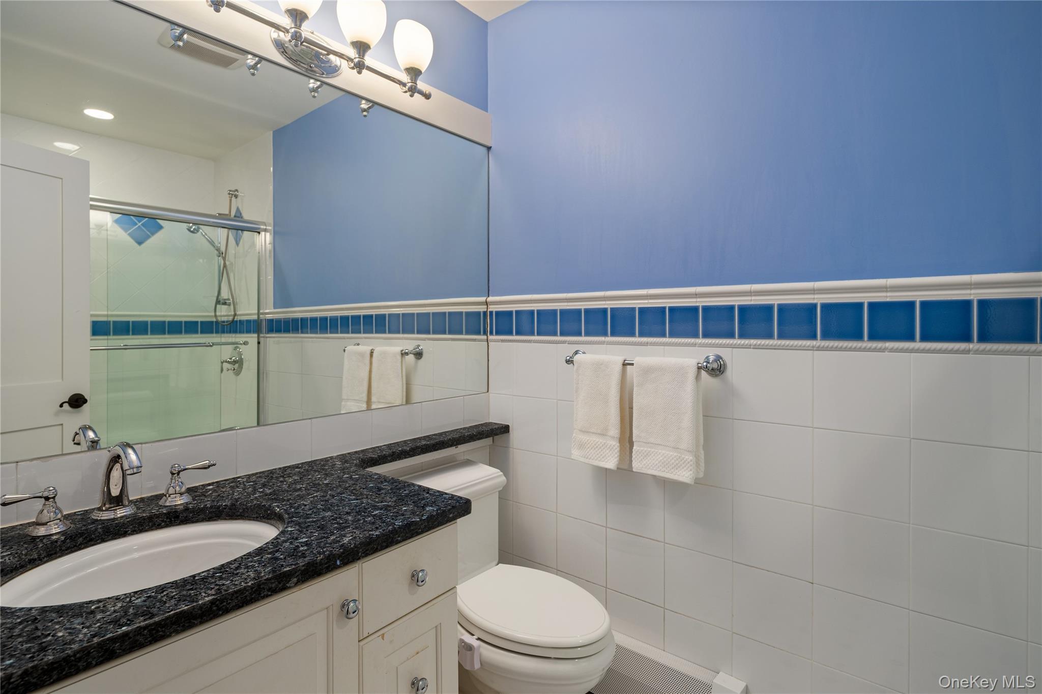 39 Mayberry Road Chappaqua, NY 10514 - Photo 32 of 44 a bathroom with a granite countertop sink a toilet and a mirror