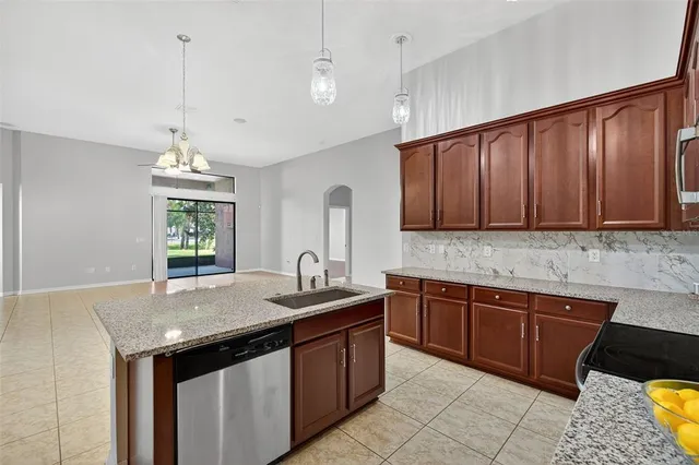 a bathroom with a granite countertop sink and a bathtub