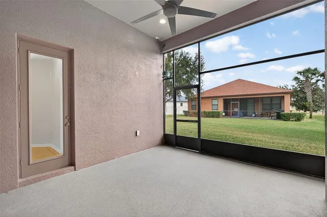 an empty room with a window and wooden floor