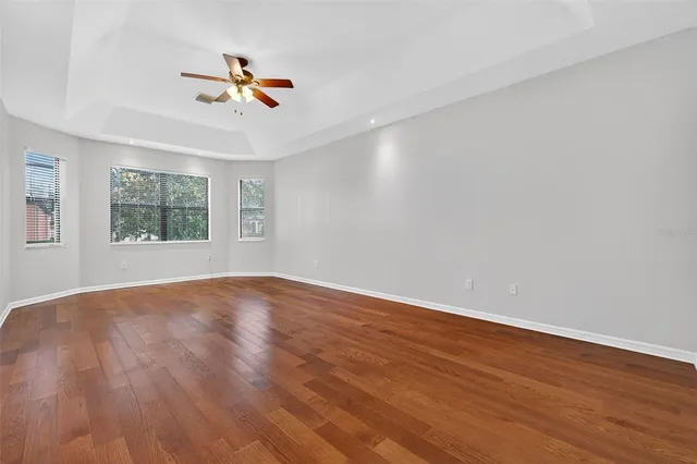 an empty room with a empty space and a ceiling fan