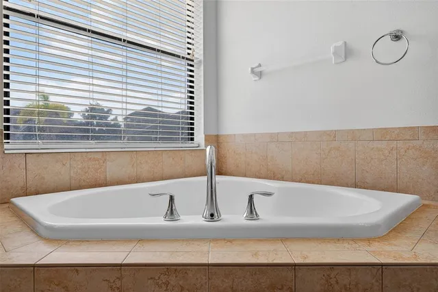 an aerial view of residential houses with outdoor space and ocean view