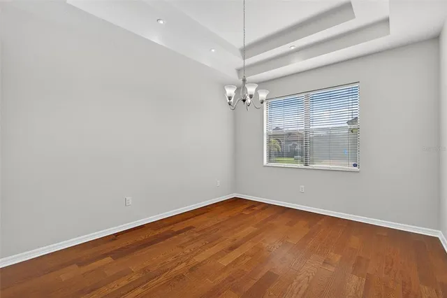 a kitchen with granite countertop a stove cabinets and a refrigerator