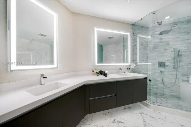 a bathroom with a sink mirror and shower