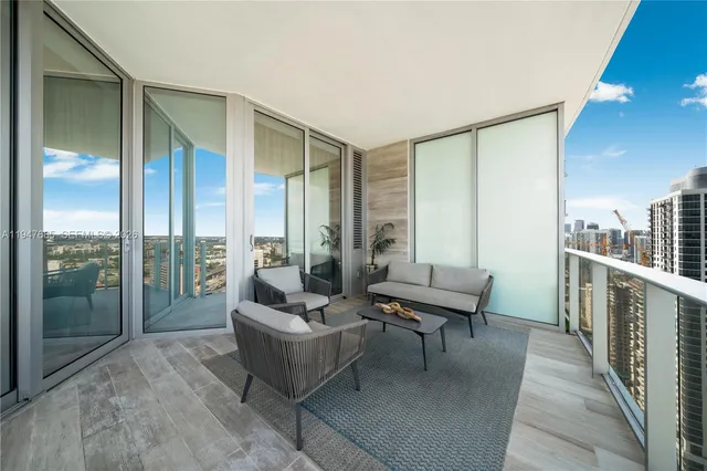 a building outdoor space with patio furniture and a potted plant