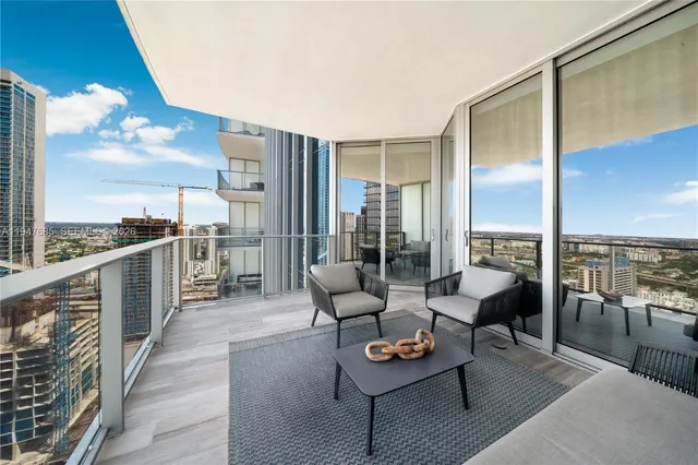 a balcony with furniture and city view