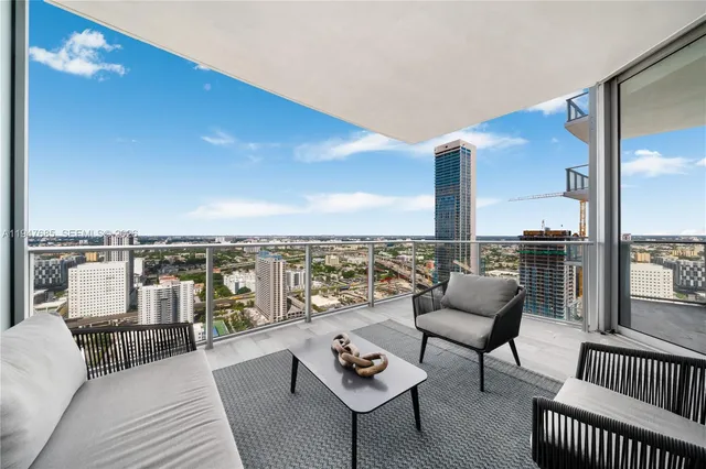 a balcony with furniture and city view