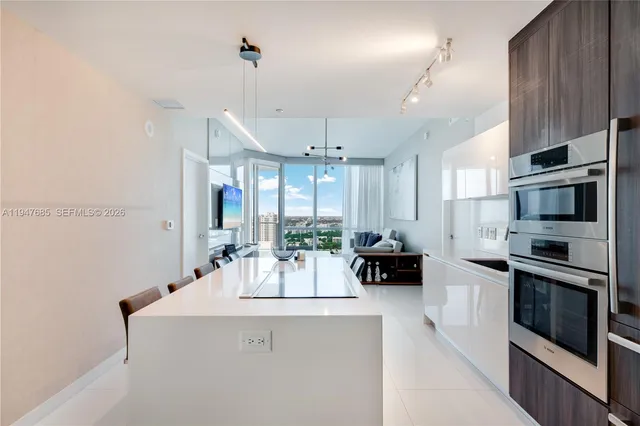 a kitchen with stainless steel appliances a stove a sink and a refrigerator