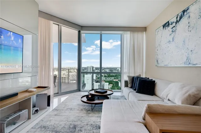 a living room with furniture and a large window