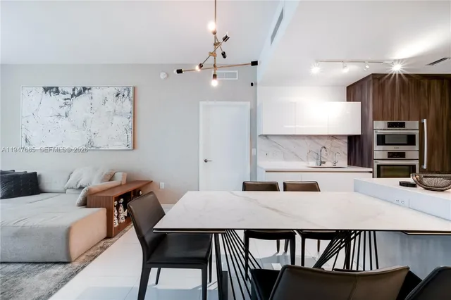 a kitchen with a table chairs and a kitchen