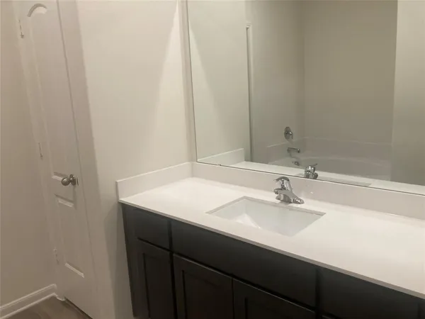a bathroom with a glass shower door