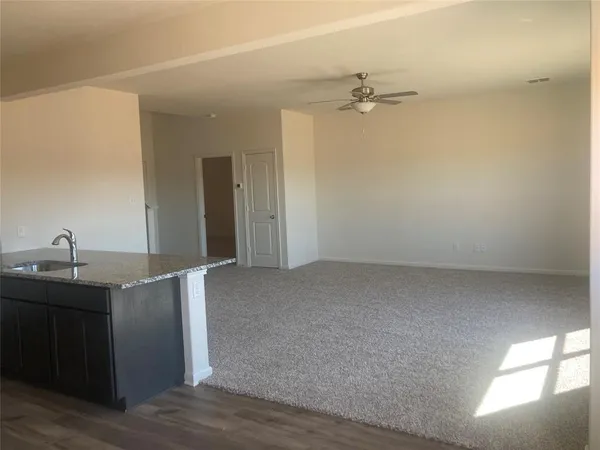 a kitchen with granite countertop a sink and cabinets