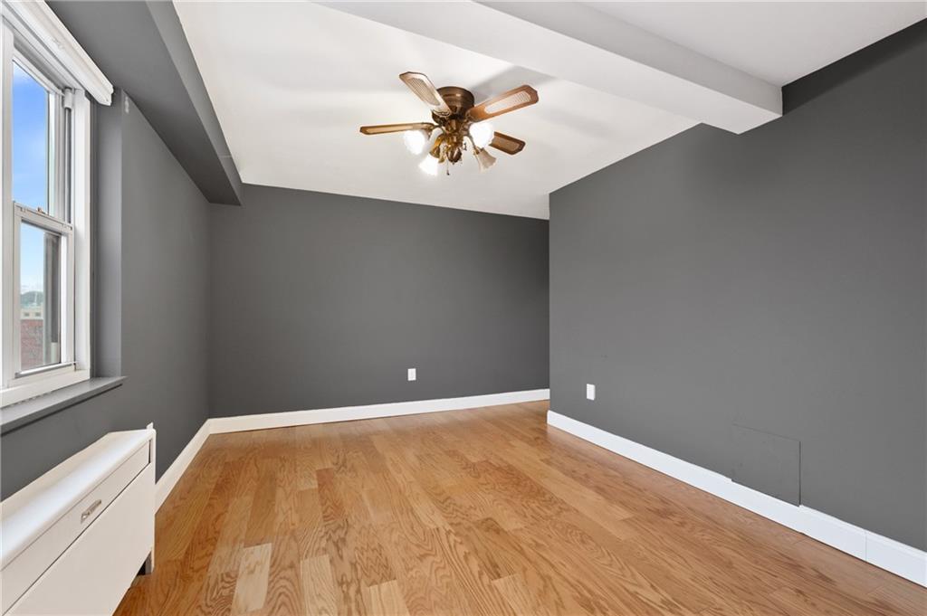 4625 Fifth Avenue, Unit 607 Pittsburgh, PA 15213 - Photo 11 of 22 a view of an empty room with window and wooden floor