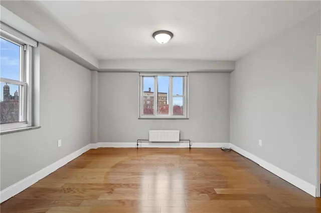 a view of a room with wooden floor and window