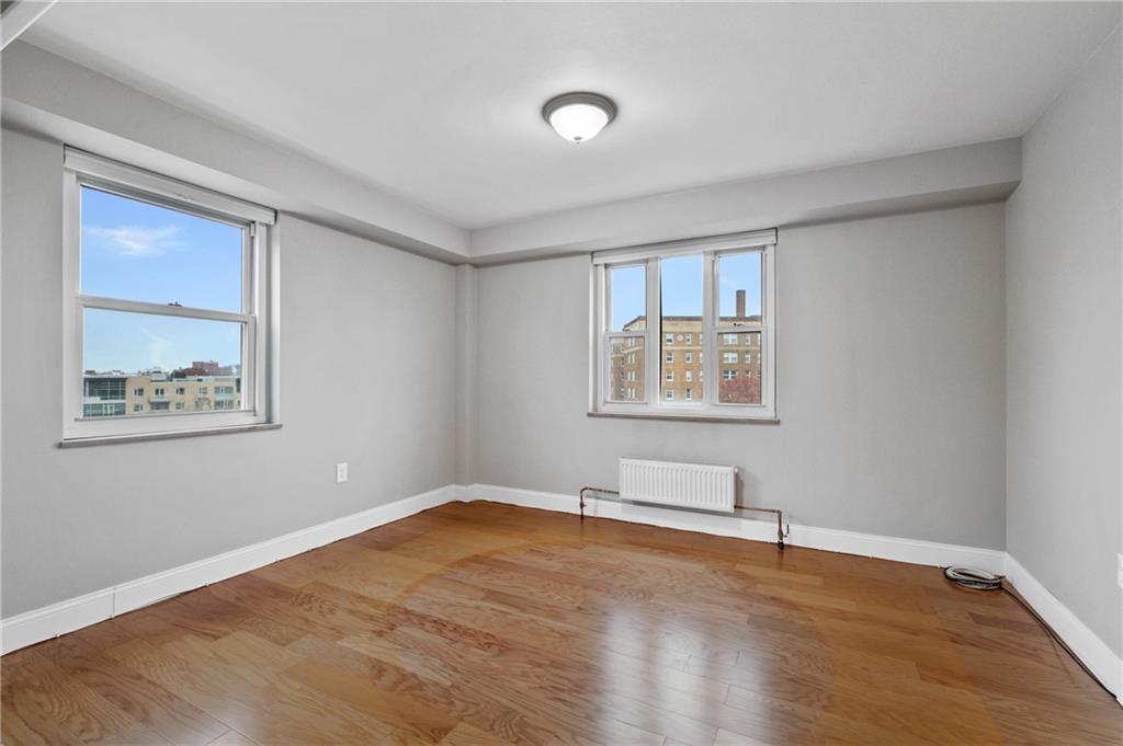 4625 Fifth Avenue, Unit 607 Pittsburgh, PA 15213 - Photo 6 of 22 a view of an empty room with wooden floor and a window