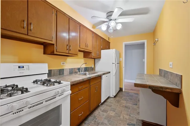 a kitchen with a sink cabinets and appliances