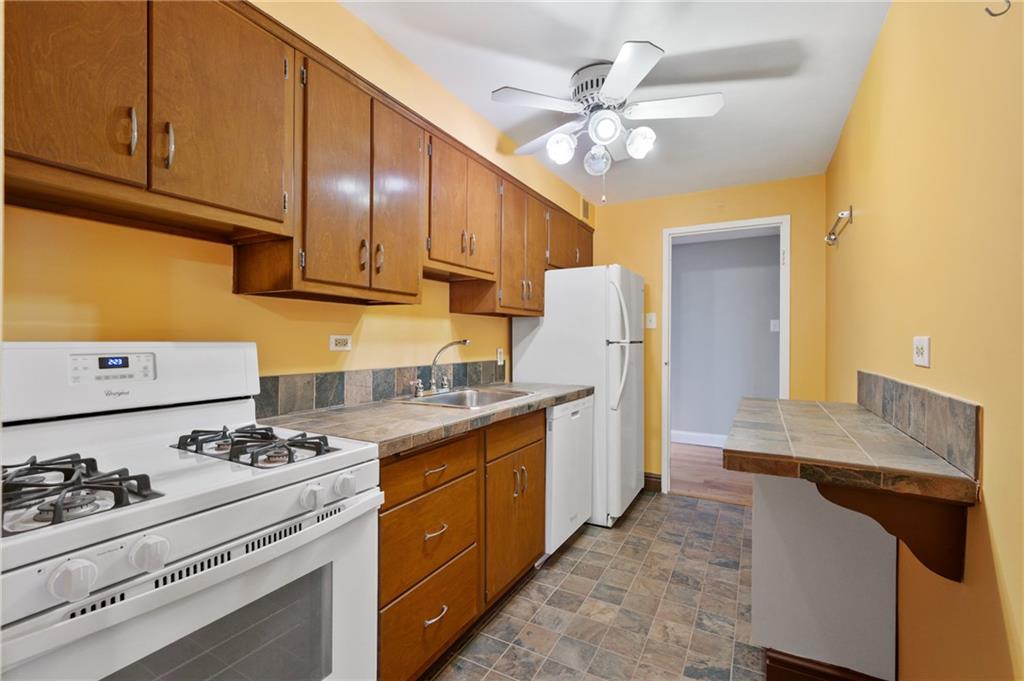 4625 Fifth Avenue, Unit 607 Pittsburgh, PA 15213 - Photo 8 of 22 a kitchen with a sink cabinets and appliances