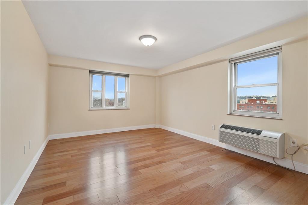 4625 Fifth Avenue, Unit 607 Pittsburgh, PA 15213 - Photo 10 of 22 a view of an empty room with a window and wooden floor