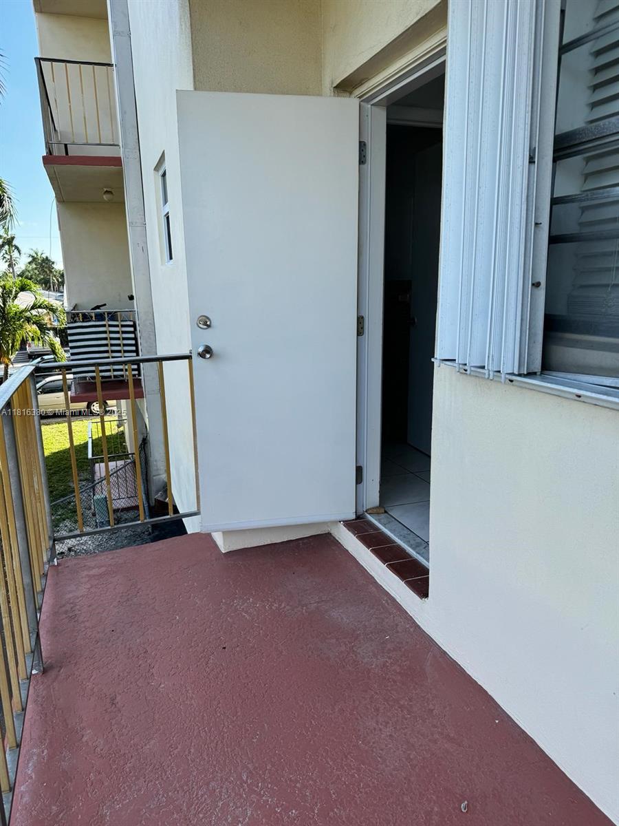 1747 Rodman Street, Unit 203 Hollywood, FL 33020 - Photo 12 of 16 a view of empty room with wooden floor and stairs
