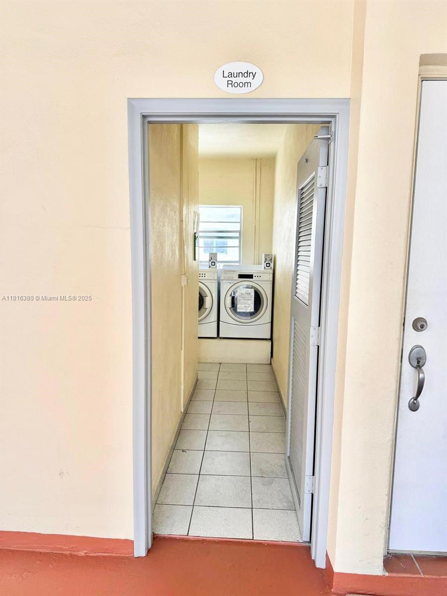 1747 Rodman Street, Unit 203 Hollywood, FL 33020 - Photo 14 of 16 a view of a hallway with wooden floor and a bathroom