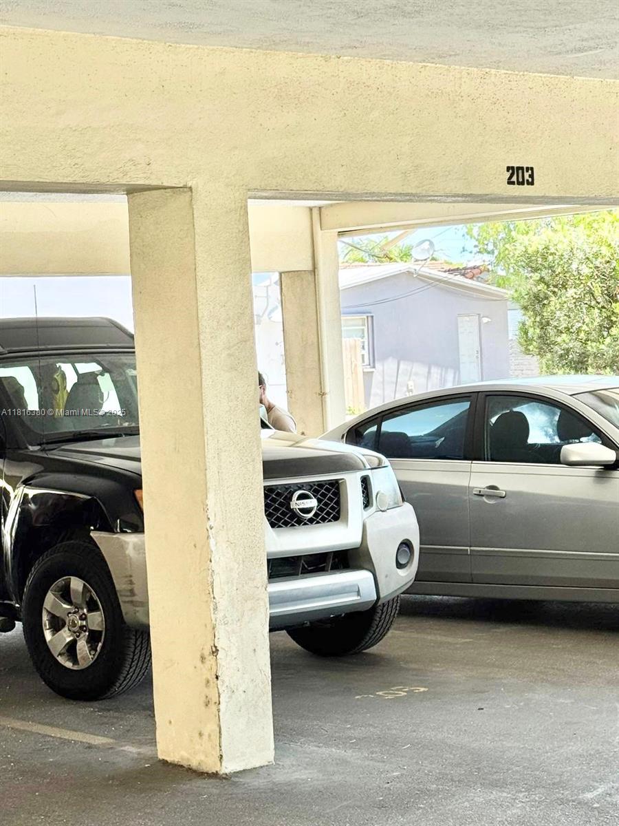 1747 Rodman Street, Unit 203 Hollywood, FL 33020 - Photo 16 of 16 a view of a car garage with a car parked