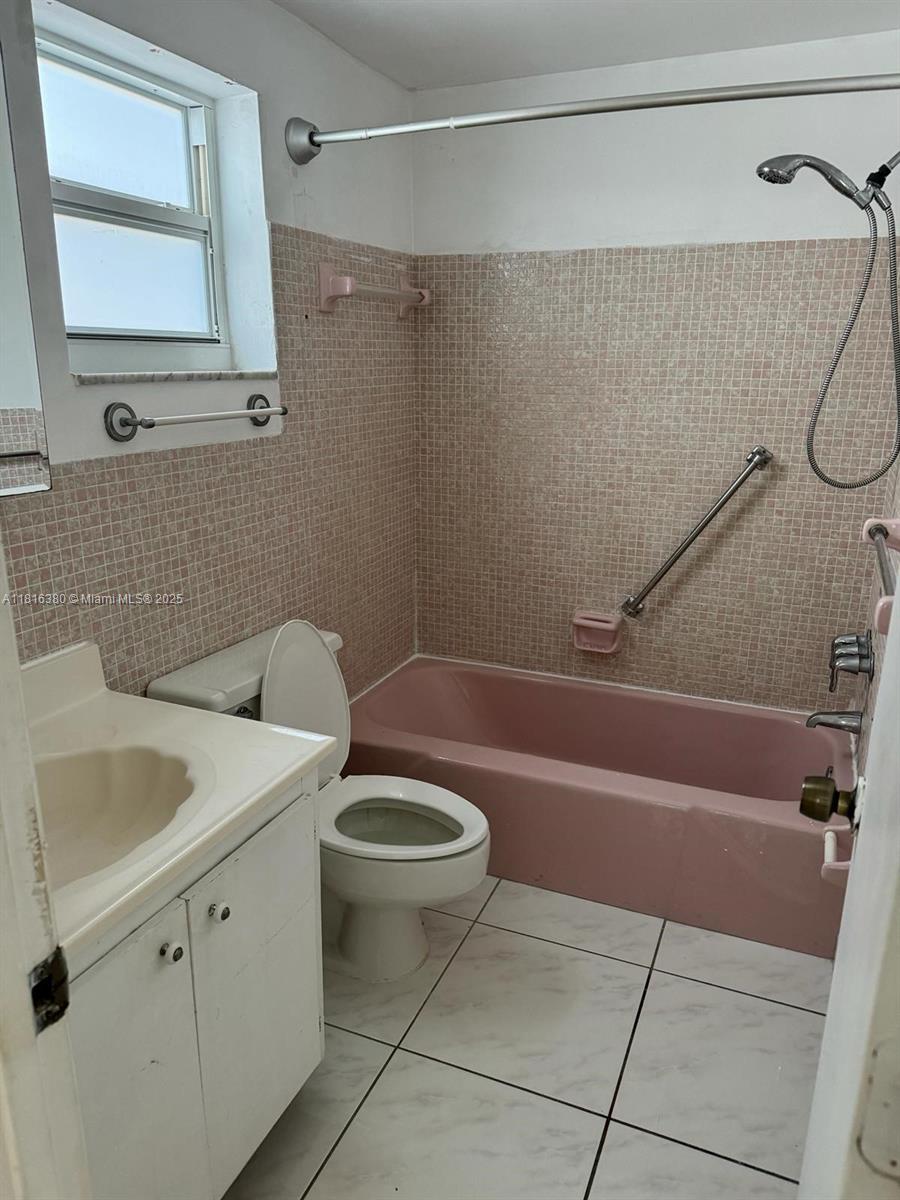 1747 Rodman Street, Unit 203 Hollywood, FL 33020 - Photo 10 of 16 a bathroom with a sink a toilet and shower