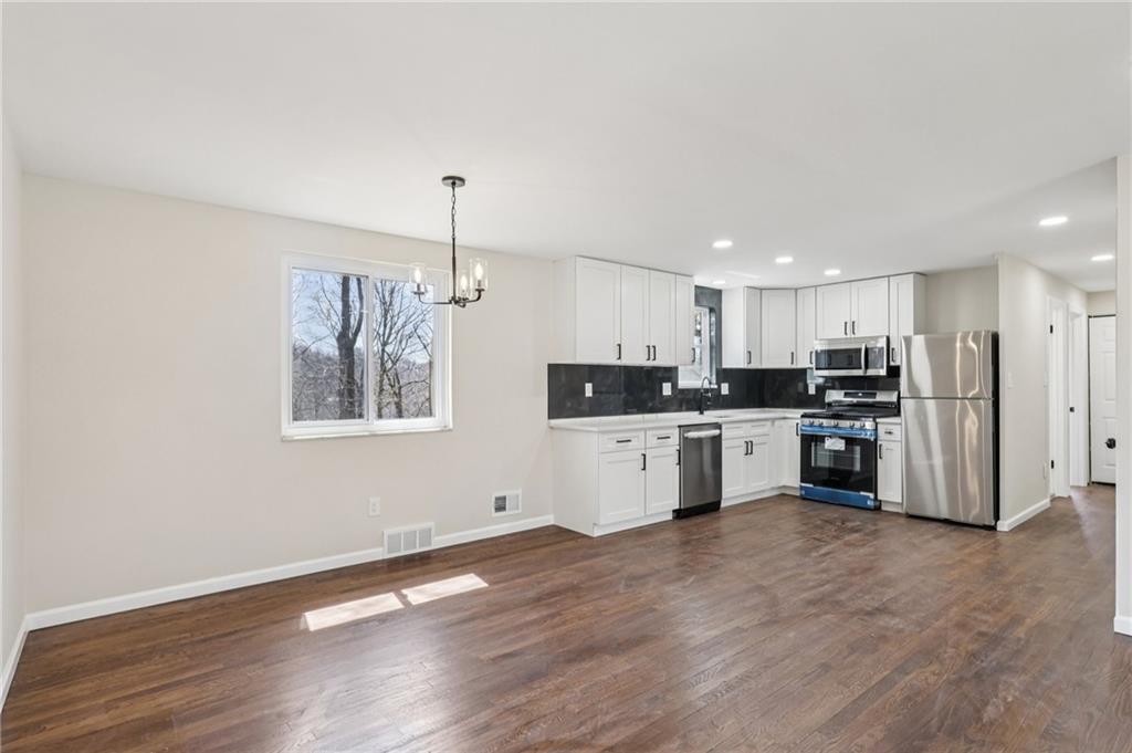 826 Blue Ridge Road Pittsburgh, PA 15239 - Photo 14 of 26 a kitchen with stainless steel appliances kitchen island a refrigerator sink and cabinets