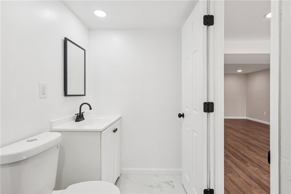 826 Blue Ridge Road Pittsburgh, PA 15239 - Photo 18 of 26 a bathroom with a sink a toilet a mirror and shower