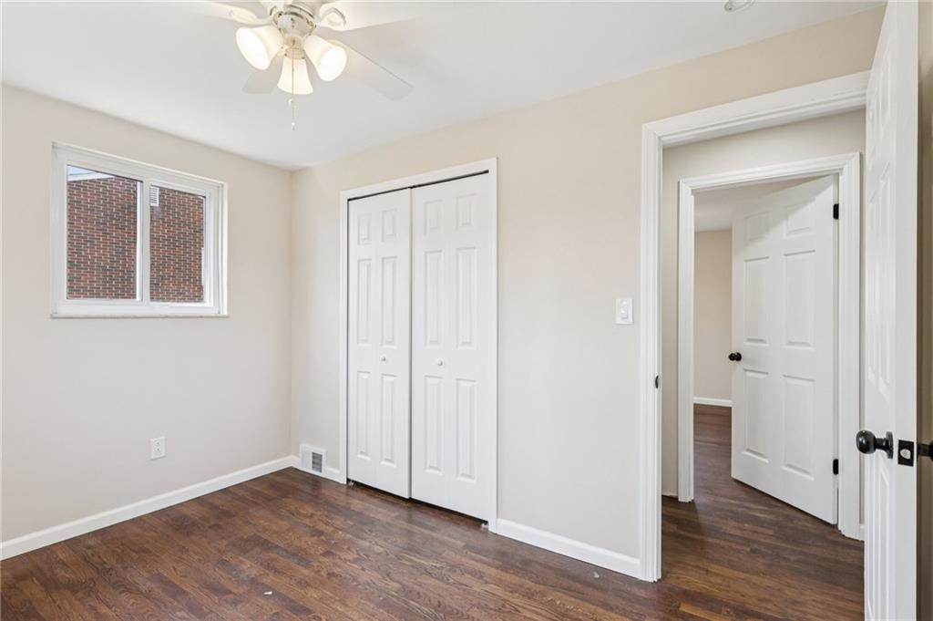 826 Blue Ridge Road Pittsburgh, PA 15239 - Photo 23 of 26 a view of an empty room with wooden floor