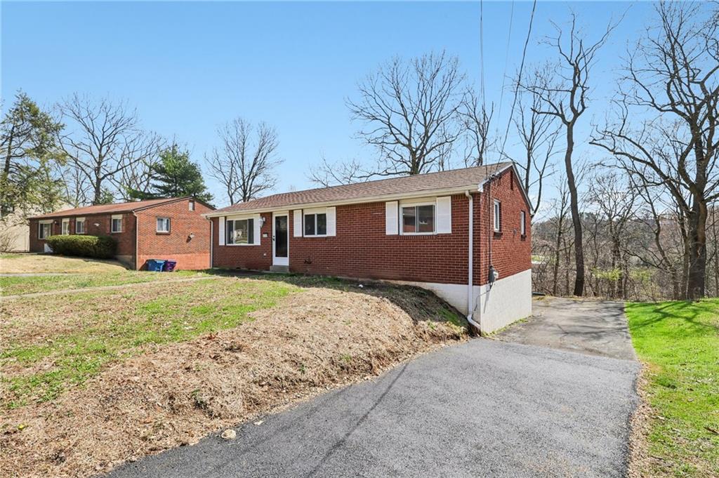 826 Blue Ridge Road Pittsburgh, PA 15239 - Photo 3 of 26 a view of a house with a yard covered in the forest