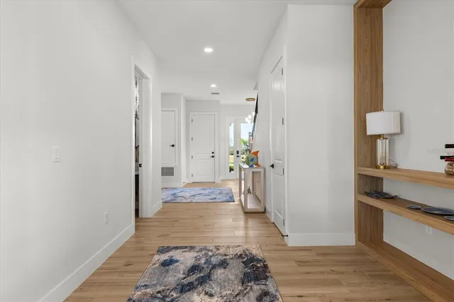 a kitchen with stainless steel appliances granite countertop a kitchen island a stove a table a sink and a refrigerator