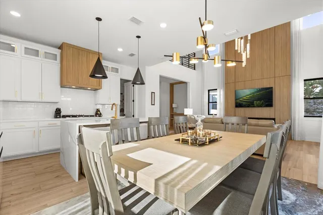 a kitchen with stainless steel appliances granite countertop a sink a stove and refrigerator