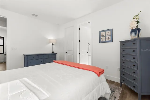 a bedroom with a large bed and a large window