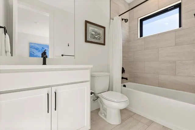 a spacious bathroom with a double vanity sink a mirror and a shower