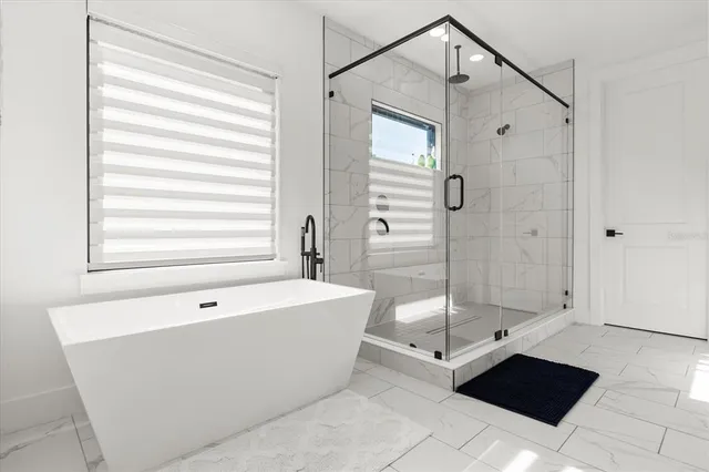 a view of a patio with a dining table and chairs under an umbrella