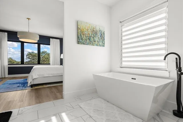 a view of a terrace with a garden and floor to ceiling window